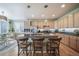 Well-appointed kitchen featuring granite counters, wood cabinets, stainless appliances, and seating at the breakfast bar at 12136 Desert Hills St, Parker, CO 80138