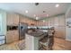 Modern kitchen with granite island, ample counter space, stainless appliances, and breakfast bar seating at 12136 Desert Hills St, Parker, CO 80138