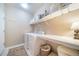 Laundry room featuring modern washer and dryer, shelving, and storage baskets at 12136 Desert Hills St, Parker, CO 80138
