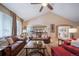 Inviting living room with vaulted ceilings, wood floors, and comfortable seating for relaxing and entertaining at 12136 Desert Hills St, Parker, CO 80138