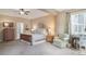 Bright, spacious main bedroom featuring a ceiling fan and a sitting area by the windows at 12136 Desert Hills St, Parker, CO 80138