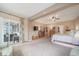 Spacious main bedroom with ceiling fan, large dresser, and sliding doors to outdoor seating area at 12136 Desert Hills St, Parker, CO 80138