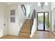 Elegant entryway showcasing a modern staircase, stylish light fixture, and access to outdoor space at 2758 Utica St, Denver, CO 80212