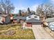 Charming brick and siding home with a two-car garage and well-maintained front yard under a bright blue sky at 7515 W Polk Ave, Littleton, CO 80123