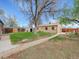 Spacious backyard featuring well-maintained lawn, mature trees, and a storage shed at 675 S Quivas St, Denver, CO 80223