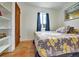 Bright bedroom featuring hardwood floors, natural light, and built-in shelves at 675 S Quivas St, Denver, CO 80223