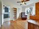 Relaxing bonus room with hardwood floors, comfortable armchair, and views into the kitchen at 675 S Quivas St, Denver, CO 80223