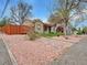 Charming single-story home with neutral-toned stucco and unique rock landscaping at 675 S Quivas St, Denver, CO 80223