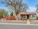 Charming single-story home with neutral-toned stucco and unique rock landscaping at 675 S Quivas St, Denver, CO 80223