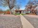 Charming single-story home with neutral-toned stucco and unique rock landscaping at 675 S Quivas St, Denver, CO 80223