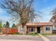 Charming single-story home with neutral-toned stucco and unique rock landscaping at 675 S Quivas St, Denver, CO 80223