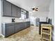 Updated kitchen features gray cabinets, modern appliances, and ample counter space at 675 S Quivas St, Denver, CO 80223