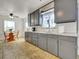 Bright kitchen featuring grey cabinets, white countertops, and an adjacent breakfast nook at 675 S Quivas St, Denver, CO 80223