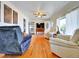 Bright living room featuring hardwood floors, ceiling fan, and large windows with abundant natural light at 675 S Quivas St, Denver, CO 80223