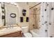 Charming bathroom with honey-bee themed accents, a shower-tub combo, and a tiled shower at 6694 S Rome St, Aurora, CO 80016