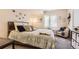 Comfortable bedroom boasts a plush bed, soft lighting, and decorative artwork for relaxation at 6694 S Rome St, Aurora, CO 80016