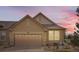 Two-story house featuring a neutral-toned exterior, a two-car garage, and well-maintained landscaping at 6694 S Rome St, Aurora, CO 80016