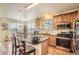 Well-equipped kitchen featuring granite countertops, stainless steel appliances, and wood cabinets at 6694 S Rome St, Aurora, CO 80016