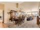 Spacious living room with a fireplace, chandelier, carpet, and high ceilings at 6694 S Rome St, Aurora, CO 80016