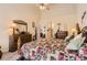 Spacious bedroom featuring a high ceiling, a decorative mirror, and an ensuite bathroom at 6694 S Rome St, Aurora, CO 80016