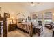 Cozy bedroom featuring carpeting, large windows, and neutral paint at 6694 S Rome St, Aurora, CO 80016