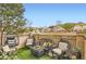 Inviting patio featuring comfortable wicker furniture, artificial grass, and sunny neighborhood views at 6694 S Rome St, Aurora, CO 80016