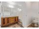 Primary bathroom featuring double sinks, a soaking tub, and neutral tones at 19466 E 59Th Dr, Aurora, CO 80019