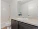 Cozy bathroom featuring a dark vanity and shower with tub at 19466 E 59Th Dr, Aurora, CO 80019