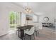 Bright dining area features sliding door access to backyard, and an elegant light fixture at 19466 E 59Th Dr, Aurora, CO 80019