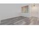 Bright, neutral room with stylish gray wood-look flooring and ample natural light at 19466 E 59Th Dr, Aurora, CO 80019