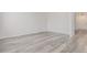 Neutral room with gray wood-look flooring and a door, ready to be personalized at 19466 E 59Th Dr, Aurora, CO 80019