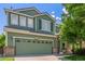 Two-story home featuring a two-car garage, light brick accents, and lush lawn at 19466 E 59Th Dr, Aurora, CO 80019
