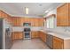 Charming kitchen features wood cabinets, stainless steel appliances, and tile flooring at 19466 E 59Th Dr, Aurora, CO 80019