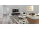 Bright living room with stylish furniture, light wood-look floors, and contemporary decor at 19466 E 59Th Dr, Aurora, CO 80019