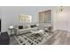 Cozy living room features modern decor, light wood-look floors, and plenty of natural light at 19466 E 59Th Dr, Aurora, CO 80019