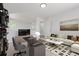 Bright living room with shelves, a sofa, and a carpet at 19466 E 59Th Dr, Aurora, CO 80019