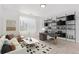 Bright living room with shelves, a sofa, and a carpet at 19466 E 59Th Dr, Aurora, CO 80019