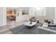 Open-concept living room flowing into the kitchen and dining area with wood-look flooring at 19466 E 59Th Dr, Aurora, CO 80019