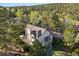 Aerial view of the home nestled among lush trees, showcasing its peaceful and private setting at 31402 N Bermuda Dunes Dr, Evergreen, CO 80439