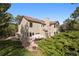 Beautiful backyard with a patio, fire pit, mature trees, and ample space for outdoor enjoyment at 31402 N Bermuda Dunes Dr, Evergreen, CO 80439