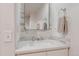 Modern bathroom featuring a white vanity, sink, and a decorative mirror at 31402 N Bermuda Dunes Dr, Evergreen, CO 80439
