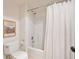 Clean bathroom features a toilet, shower with curtain, and artwork on the wall at 31402 N Bermuda Dunes Dr, Evergreen, CO 80439