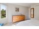 Bright bedroom features large window and dresser with custom mirror at 31402 N Bermuda Dunes Dr, Evergreen, CO 80439