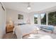 Bright, airy bedroom featuring modern décor, recessed lighting, and a bench seat in front of the large window at 31402 N Bermuda Dunes Dr, Evergreen, CO 80439