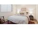 Bedroom featuring a bed with a gray comforter and neutral decor at 31402 N Bermuda Dunes Dr, Evergreen, CO 80439