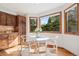 Cozy breakfast nook with hardwood floors, three large windows offering great views, and modern decor at 31402 N Bermuda Dunes Dr, Evergreen, CO 80439