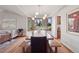 Open dining room with a large table set, modern chandelier, and scenic backyard views at 31402 N Bermuda Dunes Dr, Evergreen, CO 80439
