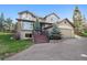 Charming home with a two-car garage, landscaped front yard, and inviting front porch area at 31402 N Bermuda Dunes Dr, Evergreen, CO 80439