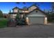 Charming home with a two-car garage, landscaped front yard, and inviting front porch area at 31402 N Bermuda Dunes Dr, Evergreen, CO 80439