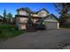 Well-lit home exterior with landscaped front yard, showcasing a cozy ambiance at dusk at 31402 N Bermuda Dunes Dr, Evergreen, CO 80439